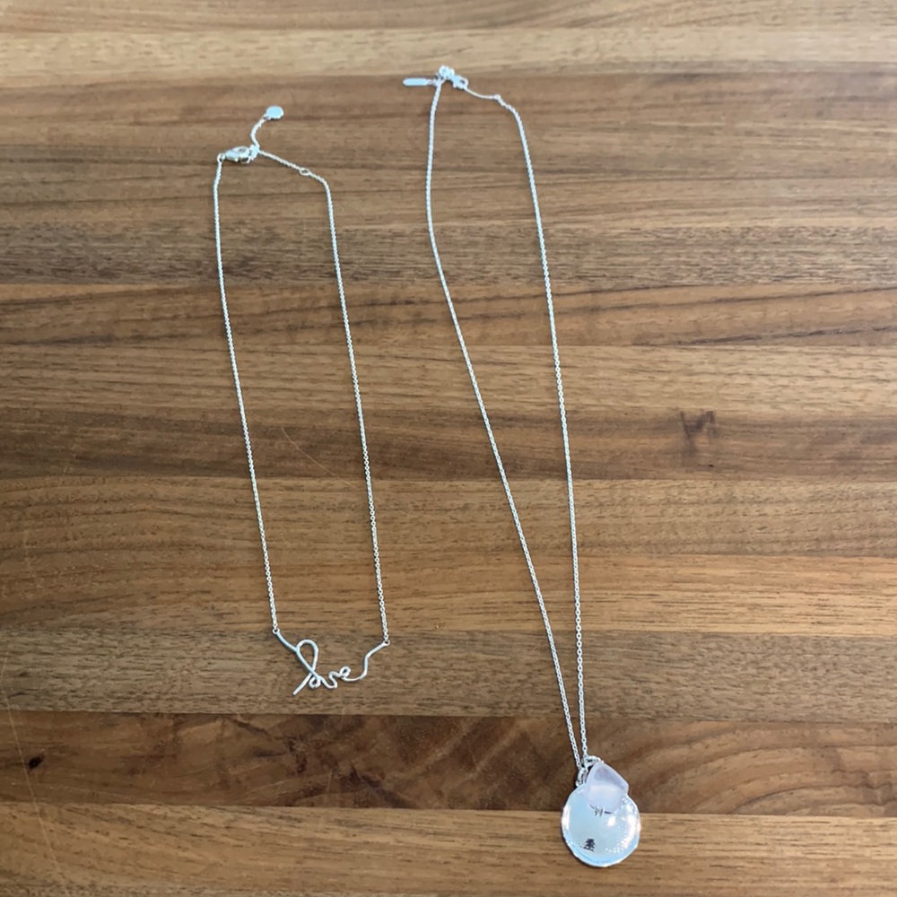 Two silver necklaces sold together.